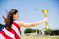 Female athlete wrapped in american flag holding fire torch Royalty Free Stock Photo