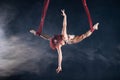 Female athletic, sexy and flexible aerial circus artist with redhead dancing in the air on the silk Royalty Free Stock Photo