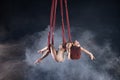 Female athletic, sexy and flexible aerial circus artist with redhead dancing in the air on the silk Royalty Free Stock Photo