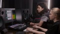 Female audio engineer and musician create song in DAW software Royalty Free Stock Photo