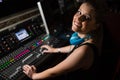 Female audio engineer using sound mixer in recording studio Royalty Free Stock Photo