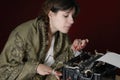 Female author typing on an old typewriter