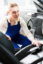 Female mechanic metering color of car upholstery