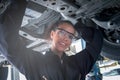 Female auto mechanic work in garage, car service technician woman check and repair customer car at automobile service center, Royalty Free Stock Photo