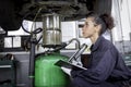 Female auto mechanic work in garage, car service technician woman check and repair customer car at automobile service center, Royalty Free Stock Photo