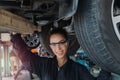 Female auto mechanic work in garage, car service technician woman check and repair customerÃ¢â¬â¢s car at automobile service center, Royalty Free Stock Photo