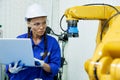 female automation machine engineer student study and inspection control robot arm machine in university or factory workshop. ai