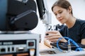 Female automation machine engineer student study and inspection control robot machine in university workshop. ai robot technology