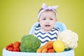 Female baby with vegetables on high chair