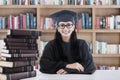 Female bachelor and books in library Royalty Free Stock Photo