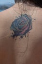 Female back with rose tattoo