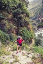 Female backpacker climbing with backpack in Himalayas, Nepal