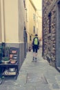 Female backpacker exploring narrow streets of medieval town.