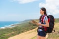 Female backpacker holding online travel guidebook