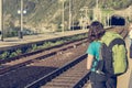 Female backpacker waiting at train station.