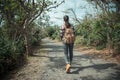 Female backpacker walking on forest path Royalty Free Stock Photo