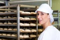 Female baker baking bread rolls Royalty Free Stock Photo