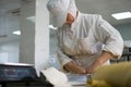 A Female Baker Cutting Pie Crust