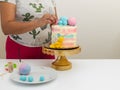 Female baker decorating a cake for a kid