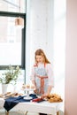 Female baker decorating tasty cupcakes with fresh berries Royalty Free Stock Photo