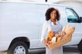 Female Baker Delivering Bread Standing In Front Of Van Royalty Free Stock Photo
