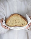 Female baker holds home made artisan organic bread fresh from the oven. Homemade sourdough bread. Homemade food Royalty Free Stock Photo