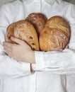 Female baker holds home made artisan organic bread fresh from the oven. Homemade sourdough bread. Homemade food Royalty Free Stock Photo