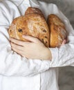 Female baker holds home made artisan organic bread fresh from the oven. Homemade sourdough bread. Homemade food Royalty Free Stock Photo