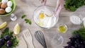 Female baker mixing egg with flour in bowl by wood spoon, cookies ingredients