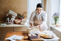 Female baker, pastry chef preparing cake order. Arabic Asian woman making cake for online delivery Royalty Free Stock Photo