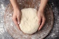 Female baker preparing bread dough at table