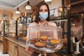 Female baker wearing medical protective mask