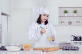 Female baker whisking eggs in a bowl to make cakes