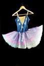Female ballet dancer costume hanging on black background Royalty Free Stock Photo