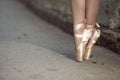 Female Ballet Dancer Legs In Laced Pointes Shoes While Posing With Straight Legs Outdoors On Tile Floor Royalty Free Stock Photo