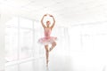 Elegant female ballet dancer in pink tutu practicing and smiling Royalty Free Stock Photo