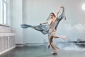 Female ballet dancer with white flowing fabric. Flow shapes and movement.