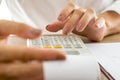 Female banker calculating expenses and income using adding machine Royalty Free Stock Photo