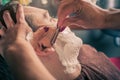 Female barber shaving a client