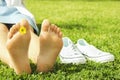 Female bare feet on mawed lawn grass. Young woman resting outdoors barefoot, take a break concept. Student on college campus yard. Royalty Free Stock Photo