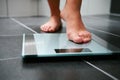 Female bare feet with weight scale Royalty Free Stock Photo