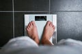 Female bare feet with weight scale Royalty Free Stock Photo