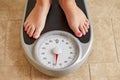 Female bare feet on weight scale Royalty Free Stock Photo