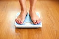 Female bare feet with weight scale Royalty Free Stock Photo