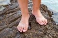 Female barefoot on a pebble beach, Croatia