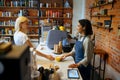 Female barista gives coffee to woman in cafe