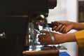 Female barista preparing espresso using coffee machine in a trendy cafe Royalty Free Stock Photo