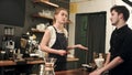 Female barista talking to customer in a cafe, taking order Royalty Free Stock Photo