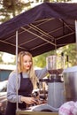 Female barrista making coffee for clients