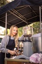 Female barrista making coffee for clients